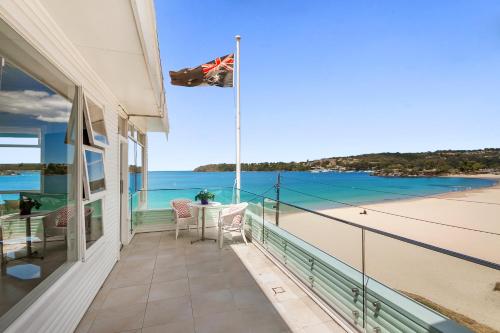 a balcony of a house with a view of the beach at The Oriana in Sydney