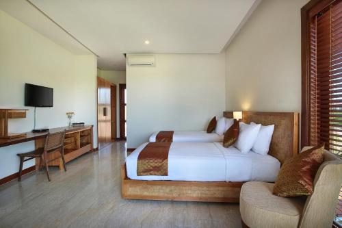 a bedroom with a bed and a desk and a couch at Casa Bonita Villa Bali in Jimbaran