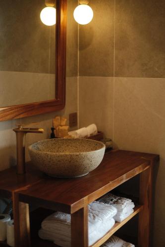 a bathroom with a bowl sink on a wooden table at Sabay Koh Rong in Koh Rong Island