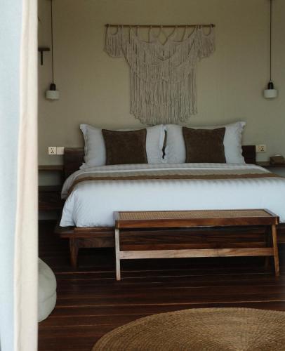 a bedroom with a large bed and a table at Sabay Koh Rong in Koh Rong Island