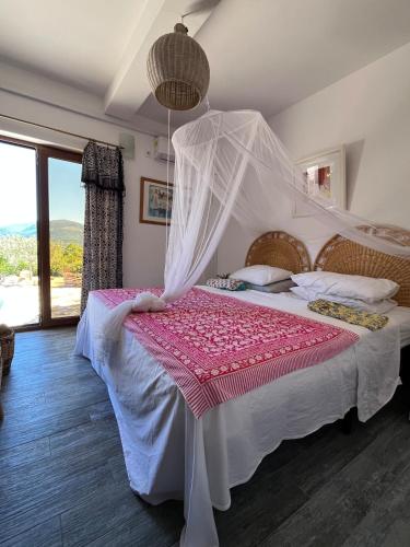 a bedroom with a bed with a mosquito net at Perfect destination !!! in Ðuraševići
