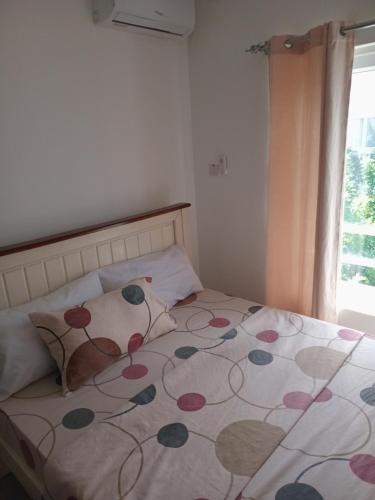 a bedroom with a bed with a flower pattern on it at Fumbatown's Finest in Mchamba Wima