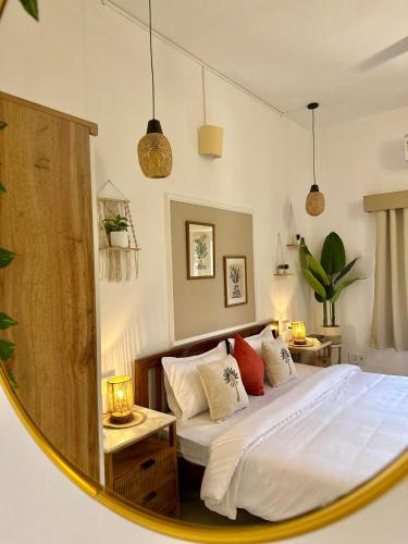 a bedroom with a bed and a mirror at The Mango Tree by ANAND VILLA in Jodhpur