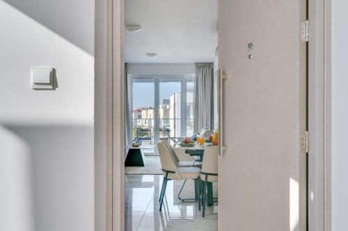 a dining room with a table and chairs and a view at Oasis Luxury Residence B101 - Pool View in Xylophaghou