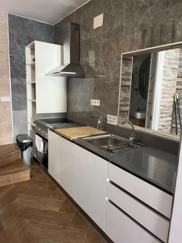 a kitchen with a sink and a stove at 3-Bedroom Home, Free Parking,10 Minutes from Seville in Camas
