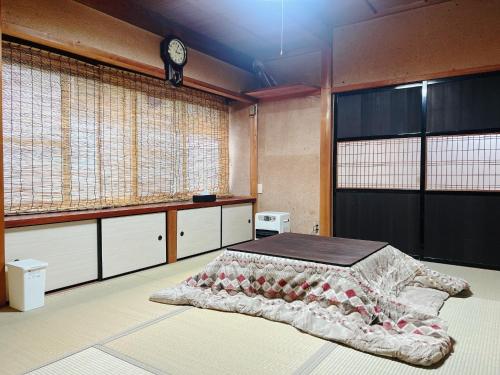 a bedroom with a bed and two large windows at JIKKA KYOTO MAIZURU Private - Kominka House for Groups & Families - Vacation STAY 21302 in Kuradani