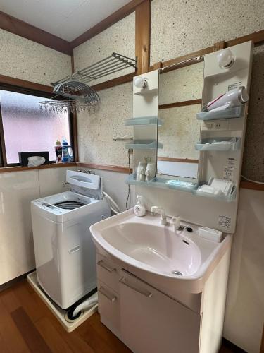 a bathroom with a sink and a washing machine at JIKKA KYOTO MAIZURU Private - Kominka House for Groups & Families - Vacation STAY 21302 in Kuradani