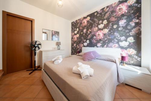 a bedroom with a bed with towels on it at A Cuor Leggero Home in Viterbo