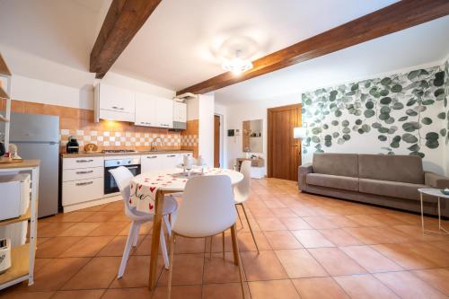 a kitchen and living room with a table and chairs at A Cuor Leggero Home in Viterbo