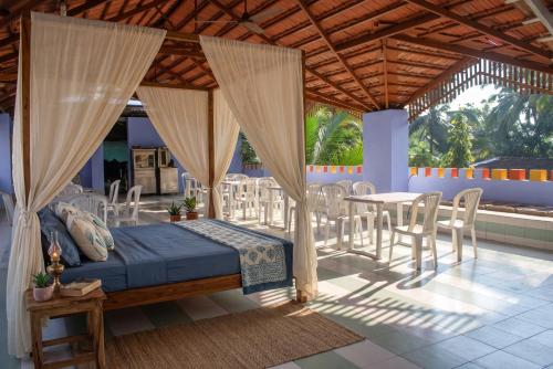 a bedroom with a bed and a table and chairs at FabHotels Fiora in Pune