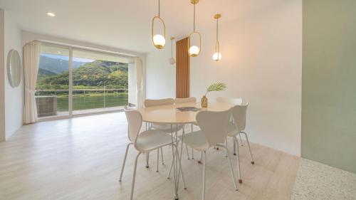 a dining room with a table and chairs and a window at Gapyeong Rowa River view Pension in Gapyeong