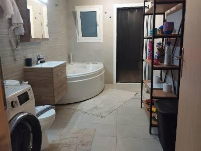 a bathroom with a tub and a toilet and a sink at Anemomylos House in Kámpos