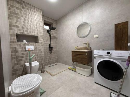 a bathroom with a sink and a washing machine at Black sea batumi in Chakvi