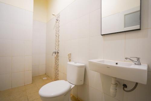 a bathroom with a toilet and a sink at Sans Hotel Beskalan Malioboro in Yogyakarta