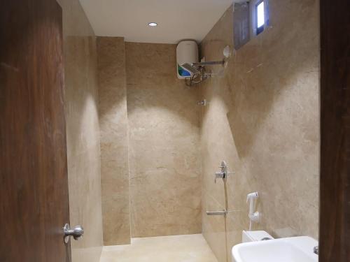 a bathroom with a shower and a sink and a toilet at IndiGo Line Hotel - Banjara Hills X Beside Paradise Biryani in Hyderabad