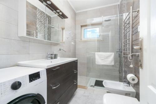 a bathroom with a sink and a washing machine at Apartments with parking space Postira, Brac - 2913 in Postira