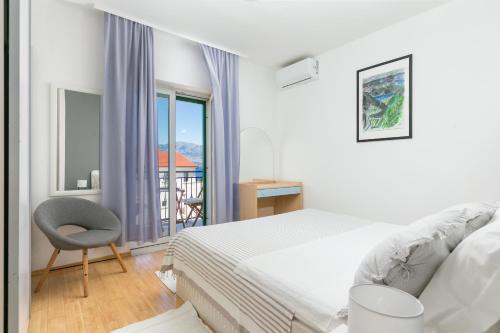 a bedroom with a bed and a chair and a window at Apartments with parking space Postira, Brac - 2913 in Postira