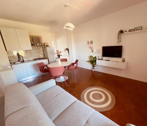 a living room with a couch and a table at DaMa s Apartment on the beach in Giardini Naxos