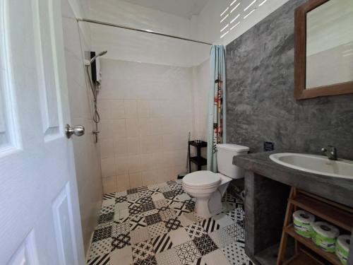 a bathroom with a toilet and a sink at DG House in Thong Sala