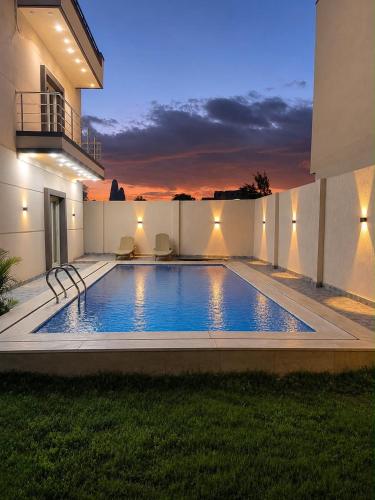 a swimming pool in the backyard of a house at La Dolce Villa with Private Pool in Borg El Arab