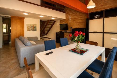 a living room with a table and a couch at Villa Pineta Grande in Lignano Sabbiadoro
