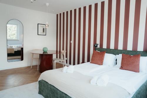 a hotel room with a bed and a table at The Haus HANS Nuremberg in Nuremberg