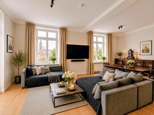 a living room with a couch and a tv at Otium Old Town Boutique in Krakow