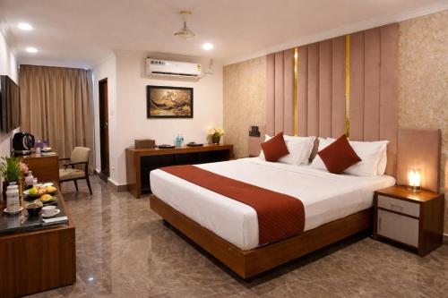a hotel room with a bed and a desk at IndiGo Line Hotel - Banjara Hills X Beside Paradise Biryani in Hyderabad