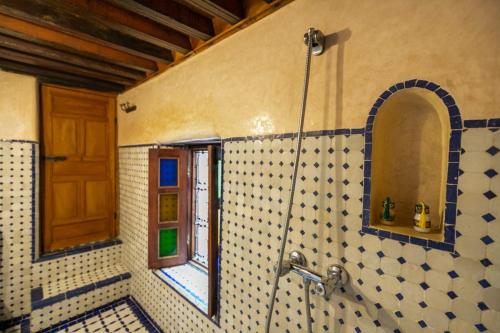 a bathroom with a shower with a window at Dar Ras Jnan -luxury stay - rooftop in Oulad Akkou