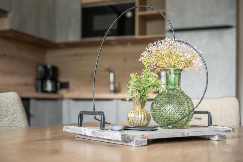a table with two vases and flowers on a table at Chalet Ahornblick in Mühlen