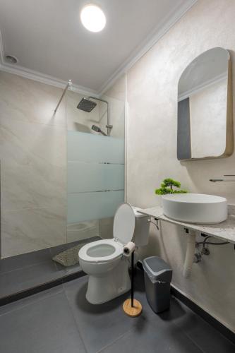 a bathroom with a white toilet and a sink at Panoramic Hill Jina in Jina
