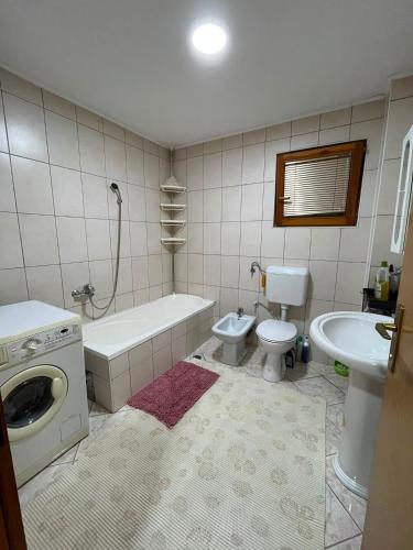 a bathroom with a tub and a toilet and a sink at Relax home in Travnik
