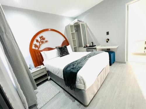 a bedroom with a large bed and a large window at MAISON MOSH ll GUEST HOUSE in Maseru