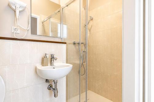 a bathroom with a sink and a shower at 1 Aprt & 5 Stylish Hotel Rooms, Comfort & Convenience Combined in Vienna