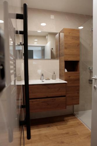 a bathroom with a sink and a mirror at Maison Camélia in Paliseul
