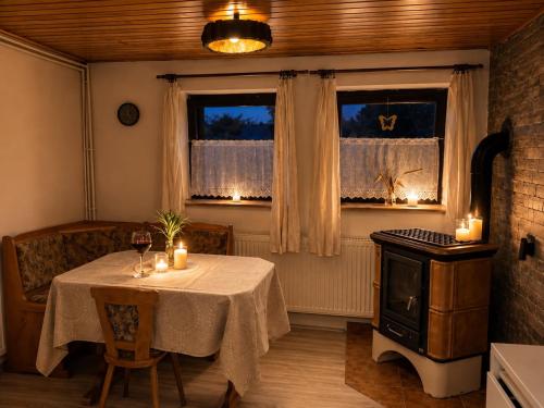 a dining room with a table and a stove at U krbu in Jindřichovice