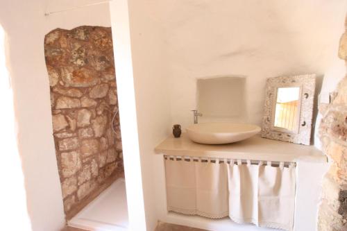a bathroom with a sink and a mirror on a counter at Tenuta Zahir in Marina di Mancaversa