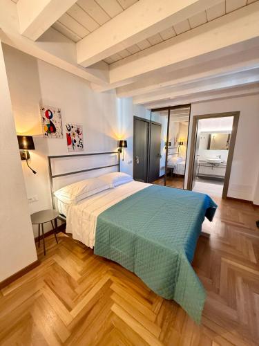 a bedroom with a large bed in a room at SiRiuS rooms & charme in Villasimius