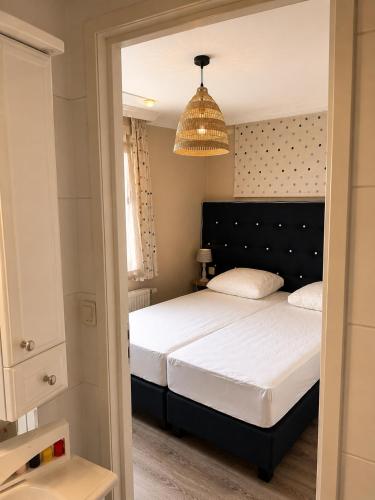 a bedroom with a bed and a chandelier at BLUE BEACH HOUSE in Breskens