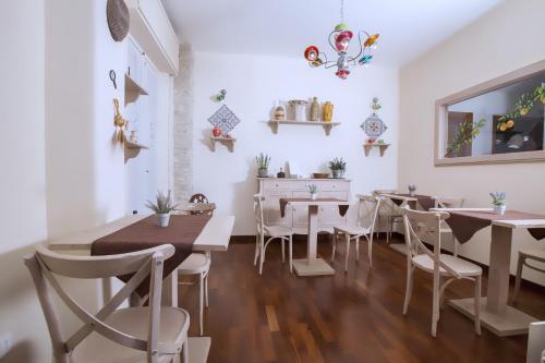 a dining room with white tables and white chairs at Stupor Mundi Bed and Breakfast in Palermo