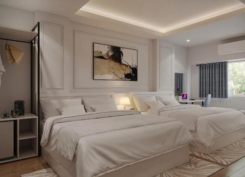 two beds in a bedroom with white walls at Market Ben Thanh Kas Hotel Passion in Ho Chi Minh City