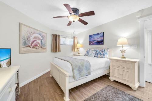 a bedroom with a bed and a ceiling fan at Aquavista 304W in Panama City Beach