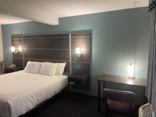a hotel room with a bed and a desk at Landmark Inn in Osawatomie