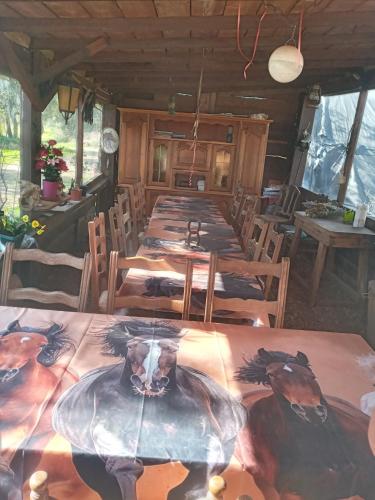 a room with tables and chairs with a painting on the table at Du puits de Riquier écologique in Régusse
