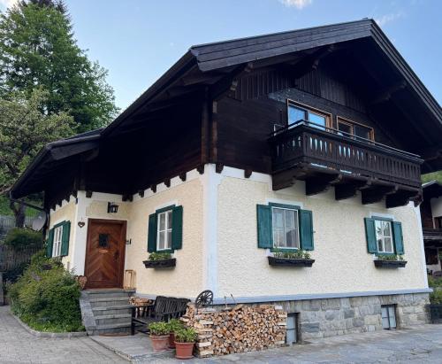 a house with a balcony on top of it at Ferienhaus Kollinger in Kaprun
