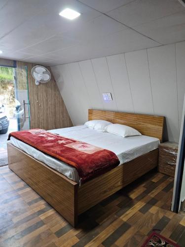 a bedroom with a large bed in a room at Monal Nests in Champawat