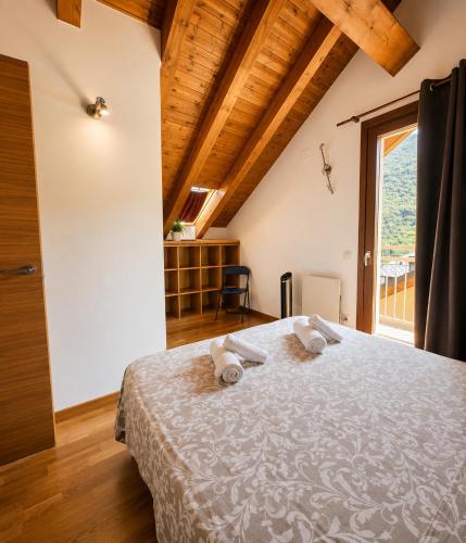 a bedroom with a bed with two towels on it at Apartaments Sort Pirineus in Sort