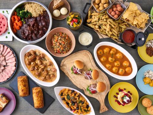 a table filled with different types of food in bowls at Mercure Urabandai Resort & Spa in Kitashiobara