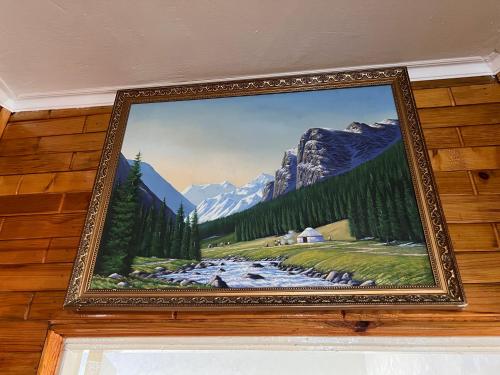 a picture of a painting of a river and mountains at Altyn Sandyk in Karakol