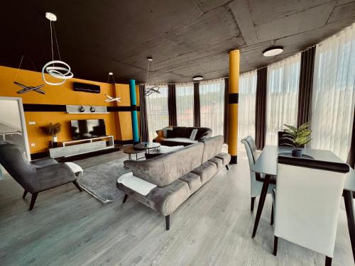 a living room with a couch and a table at L&A Apartments in Dragash